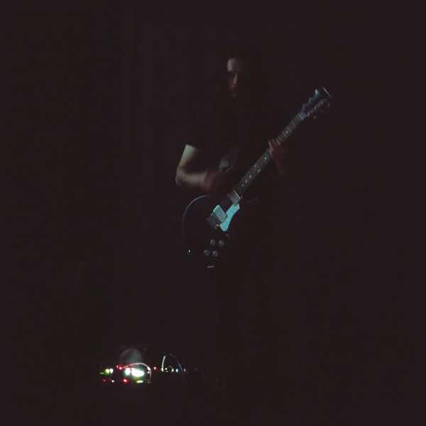 Man playing guitar in the dark